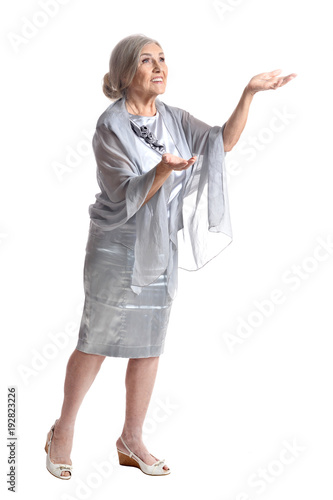  senior woman posing and showing something on white background