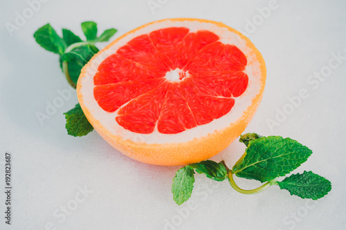 grapefruit on a wgite background - grapefruit with mint leaves. Isolated on white background.