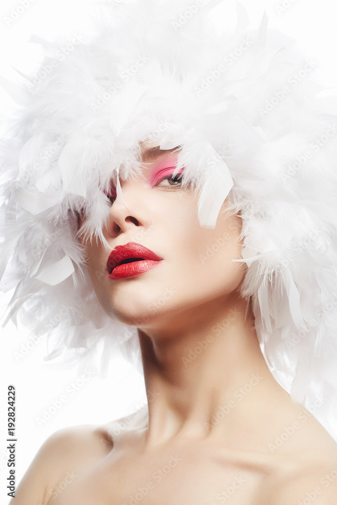 Beautiful Girl in white feathers. Beauty Make-up