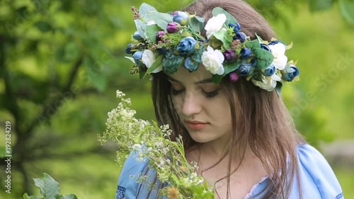 Summer lifestyle of beautiful woman holding in her hands bouquet of wild flowers. photo