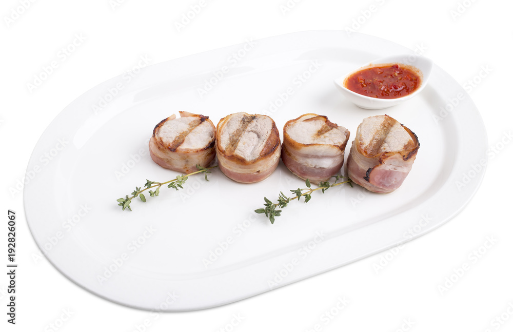 Grilled pork fillet wrapped in bacon.