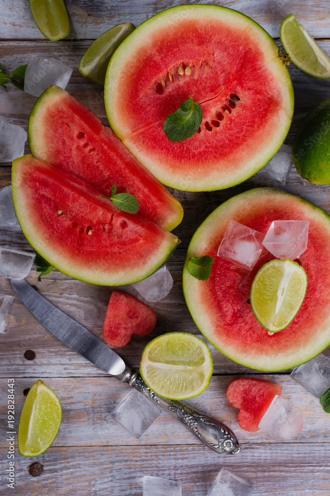 Fresh ripe watermelon slices, lime and mint on wooden table Fresh ripe watermelon slices, lime and mint on wooden table