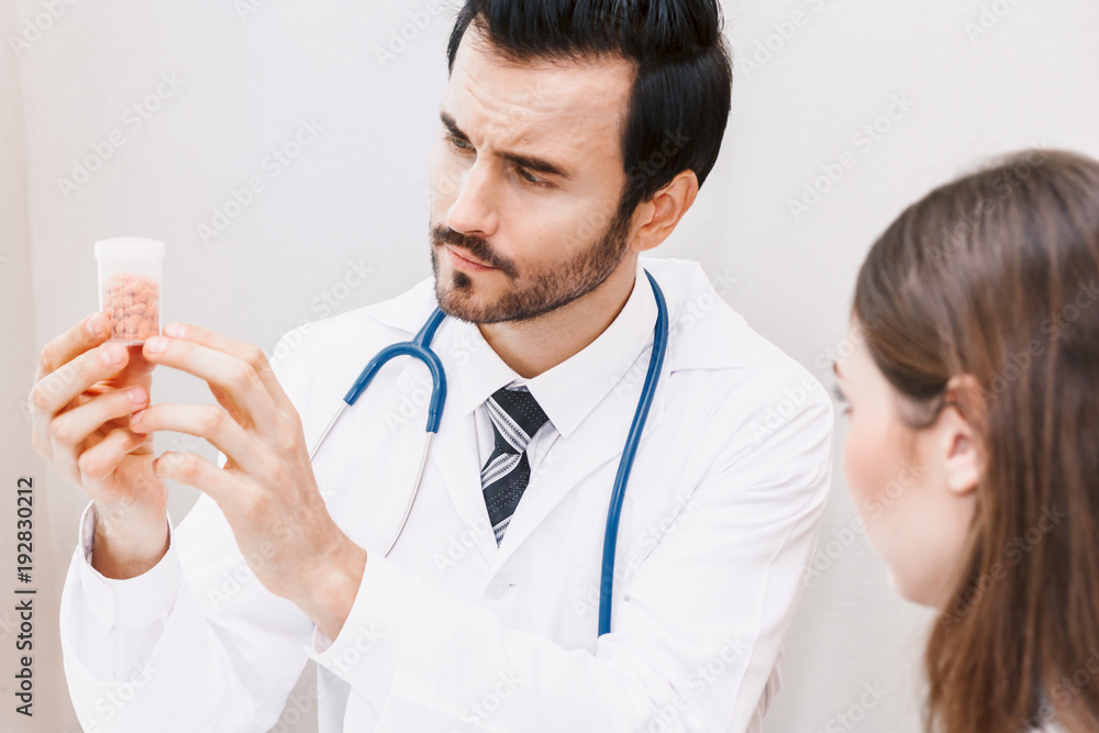 Doctor holding pill with patient in hospital.healthcare and medicine Doctor holding pill with patient in hospital.healthcare and medicine