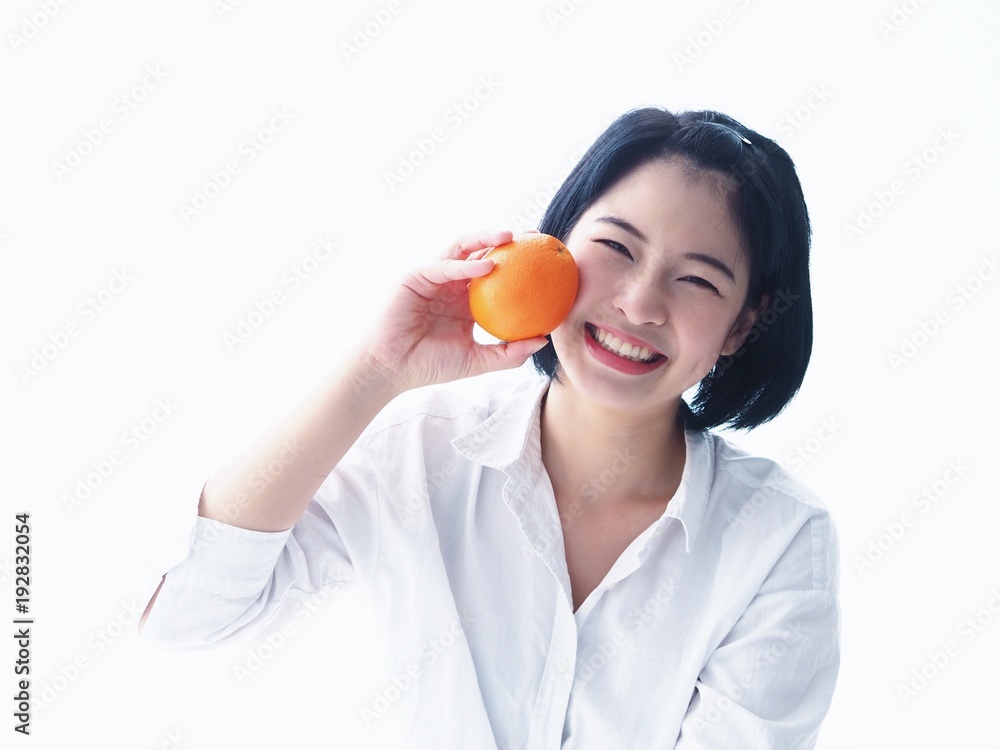 Young Asian woman holding salad bowl and fresh fruit,she's happy and joyful with this meal in the morning. Young Asian woman holding salad bowl and fresh fruit,she's happy and joyful with this meal in the morning.