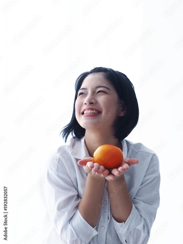 Young Asian woman holding salad bowl and fresh fruit,she's happy and joyful with this meal in the morning. Young Asian woman holding salad bowl and fresh fruit,she's happy and joyful with this meal in the morning.