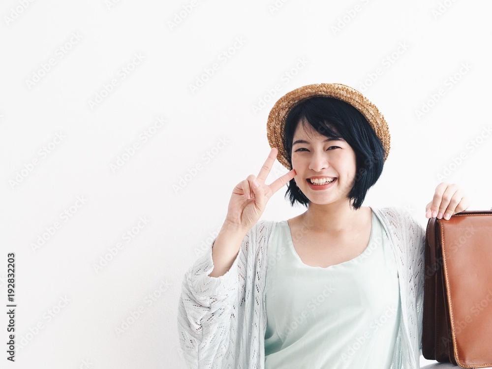 Happy Young Asian woman With vintage brown luggage standing over white background,copy space,Asian travel concept.