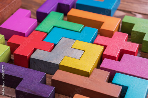 The concept of logical thinking. Geometric shapes on a wooden background.