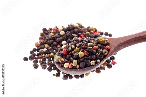 Top view of a wooden spoon full of allspice seeds isolated on white background, shallow depth of field, front focus