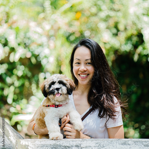Photography Portrait of a lovely Asian woman while carrying her Shih Tzuh dog