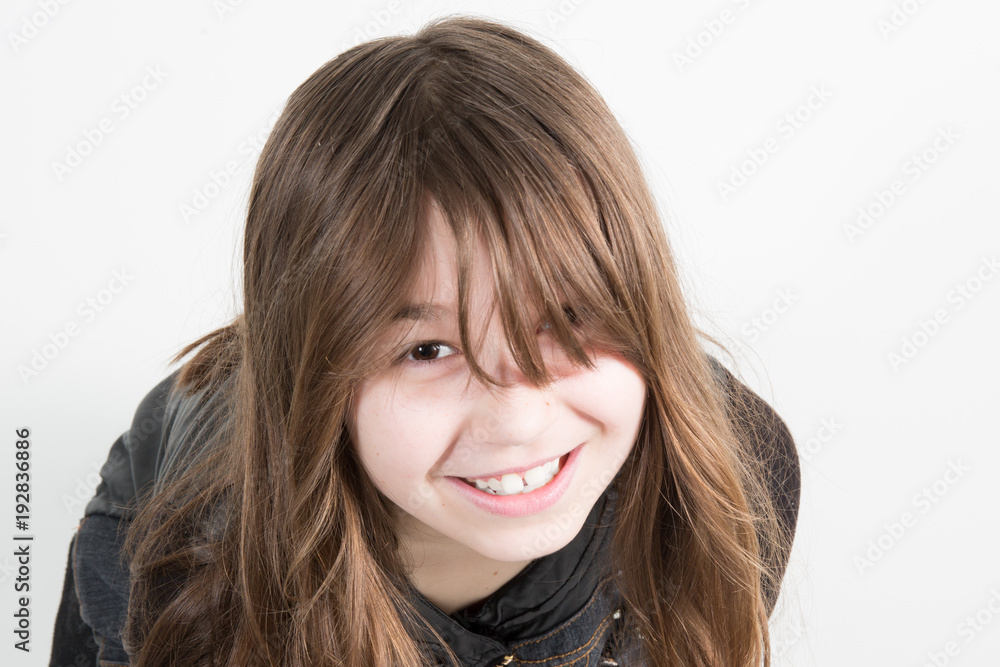 Portrait of a charming little girl smiling at camera, isolated on white background Portrait of a charming little girl smiling at camera, isolated on white background
