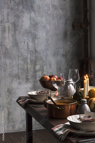 Rustic table setting with pumpkin soup and pumpkins