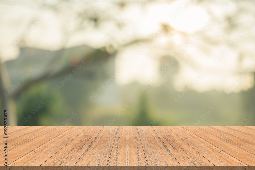 Empty wood table top on nature green blurred background at garden,space for montage show products Empty wood table top on nature green blurred background at garden,space for montage show products