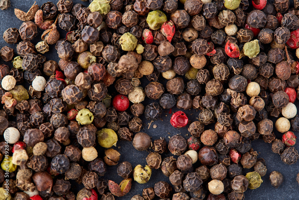 Mix of grind black pepper and black, white, red and yellow peppercorn. Selective focus. Mix of grind black pepper and black, white, red and yellow peppercorn. Selective focus.