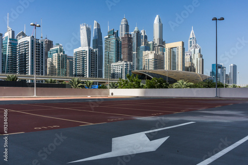 Photography Skyscrapers in Dubai Marina, empty car park, metro station