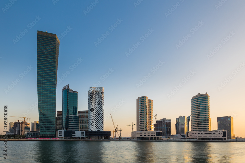 Sunset over embankment of Dubai Creek, Business bay at evening. Dubai, UAE Sunset over embankment of Dubai Creek, Business bay at evening. Dubai, UAE
