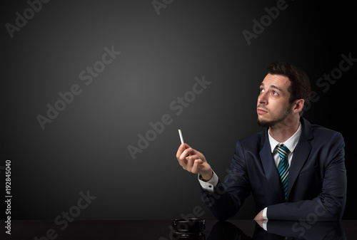 Businessman holding cigarette.