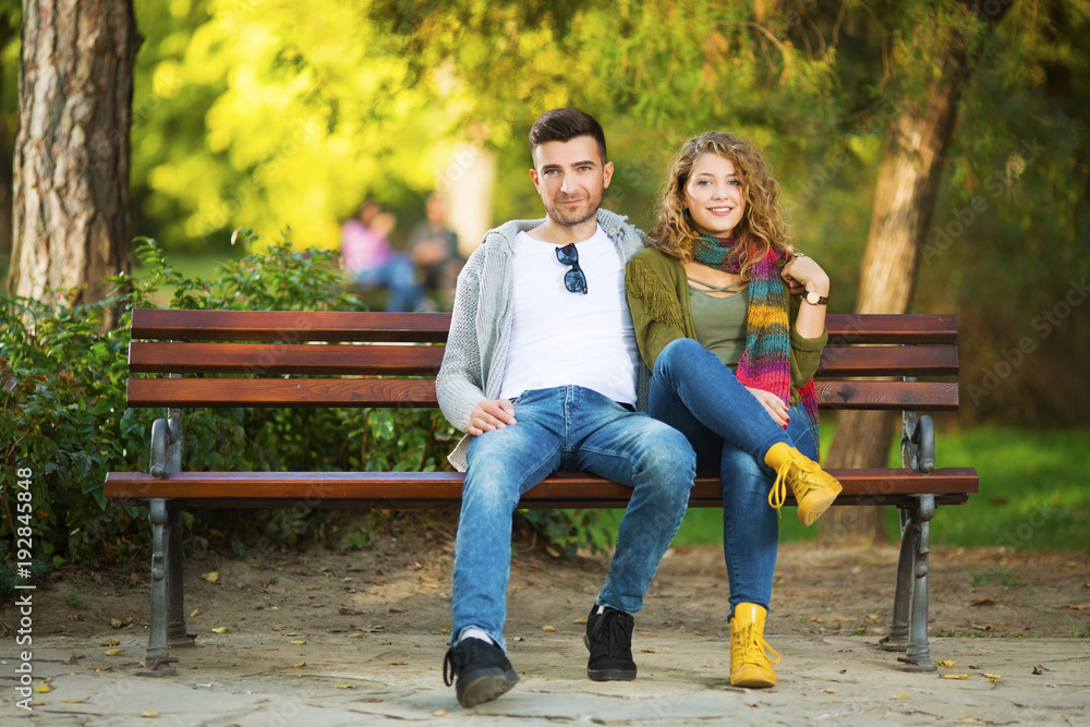 Fototapeta premium Young couple in park in front of a camera