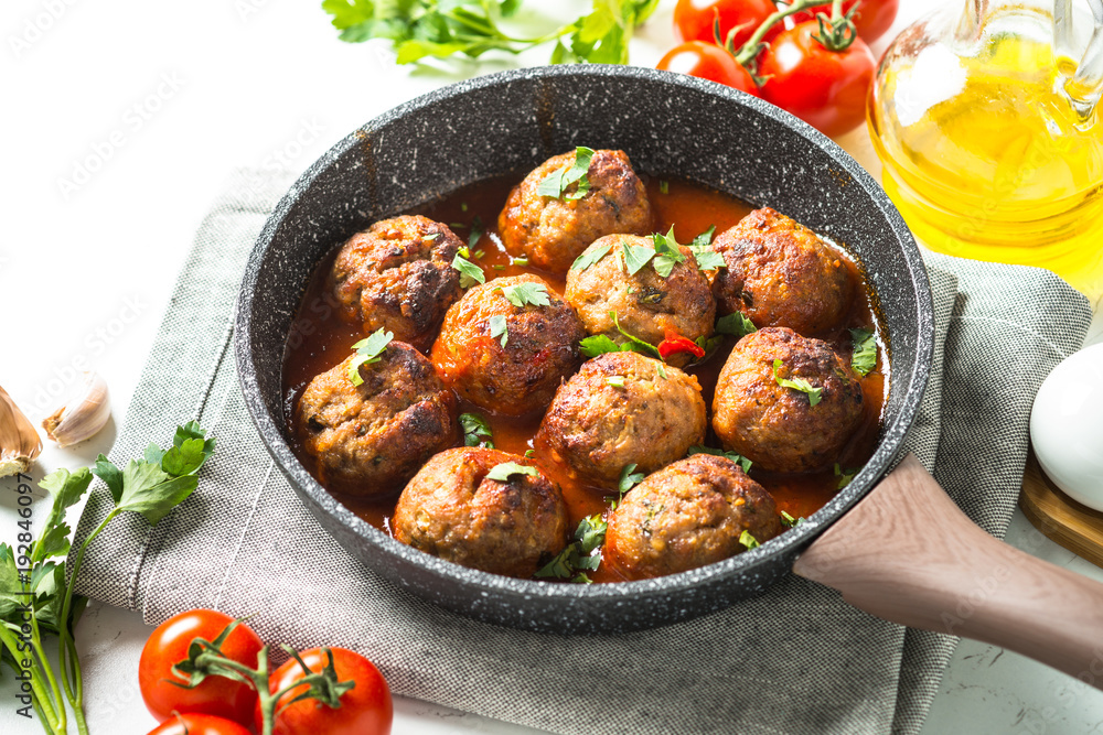 Meat balls in tomato sauce in a frying pan. Meat balls in tomato sauce in a frying pan.