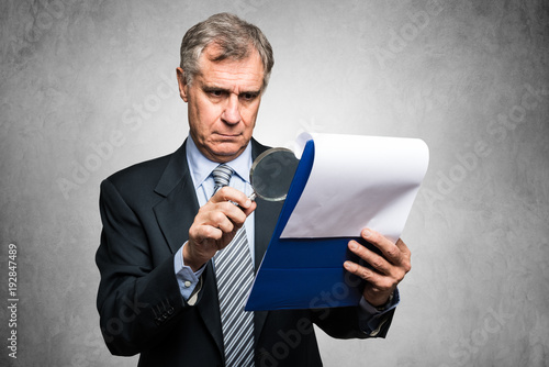 Fotografija Businessman analyzing a contract