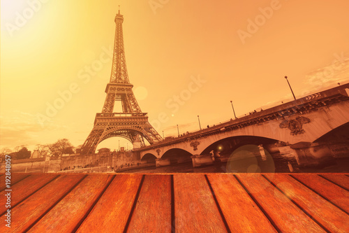 Empty wooden floor and Eiffel tower landscape view on sunset.