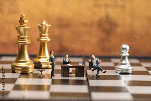 group of businessman is meeting or discuss.background decorate by chess and world map. illustrate negotiate ,discuss ,meeting and business collaborative