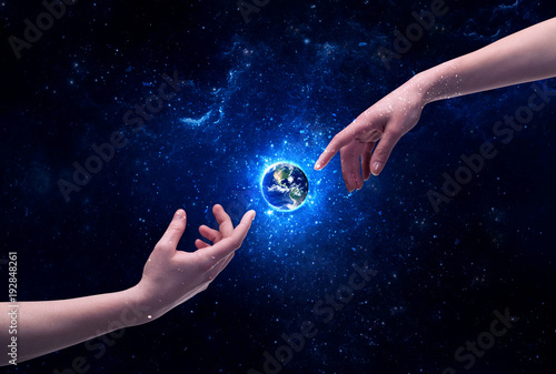 Hands in space touching planet earth