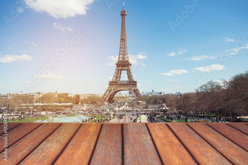 Empty wooden floor and Eiffel tower landscape view on sunset.