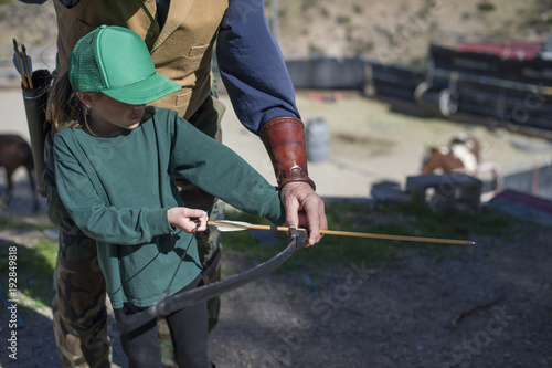 Girl taking archery lessons