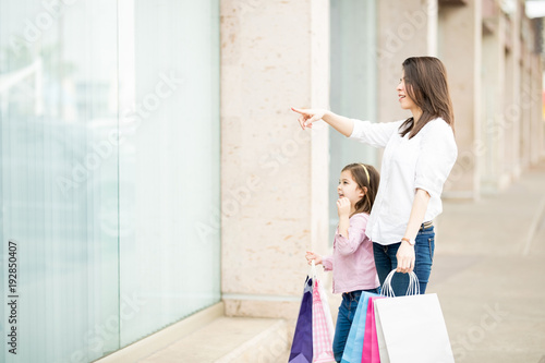 Mother and daughter window shopping