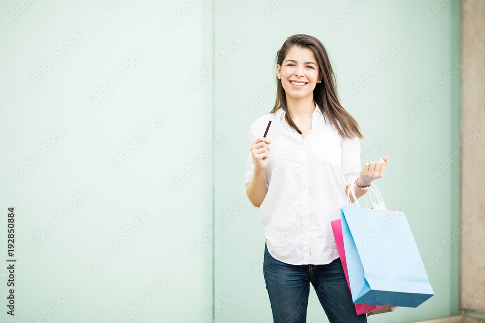 Attractive latin woman using a credit card for shopping Attractive latin woman using a credit card for shopping
