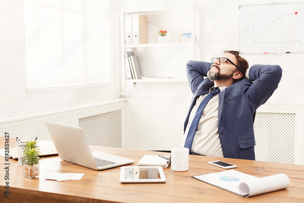 Relaxed businessman in modern white office Relaxed businessman in modern white office