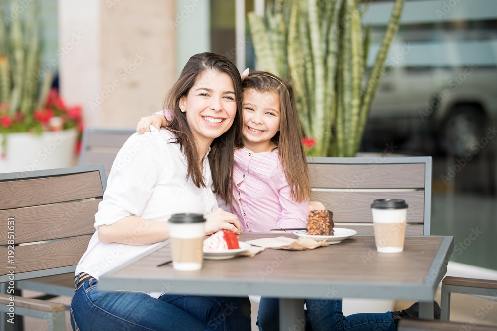 Hispanic mother and daughter in a cafe