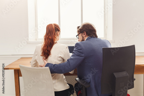 Sexual harassment at work, back view