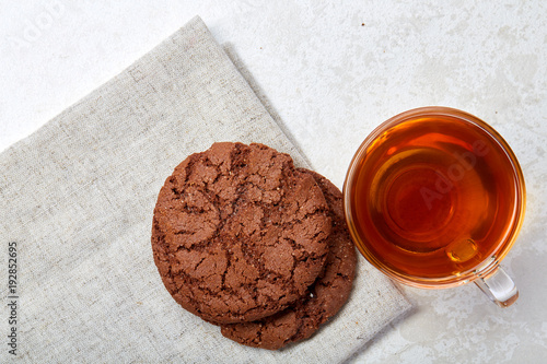 Top view close up picture of glass teacup with biscuits isolated on white background, frontfocus, shallow depth of field photo