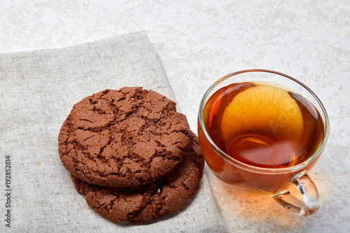 Top view close up picture of glass teacup with biscuits isolated on white background, frontfocus, shallow depth of field photo