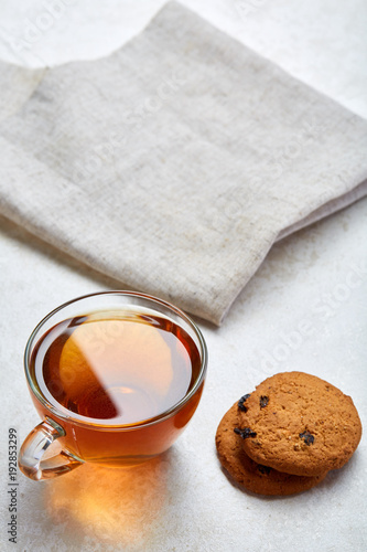 Top view close up picture of glass teacup with biscuits isolated on white background, frontfocus, shallow depth of field photo