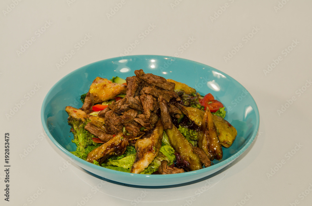 pieces of meat stewed with vegetables on a white background pieces of meat stewed with vegetables on a white background