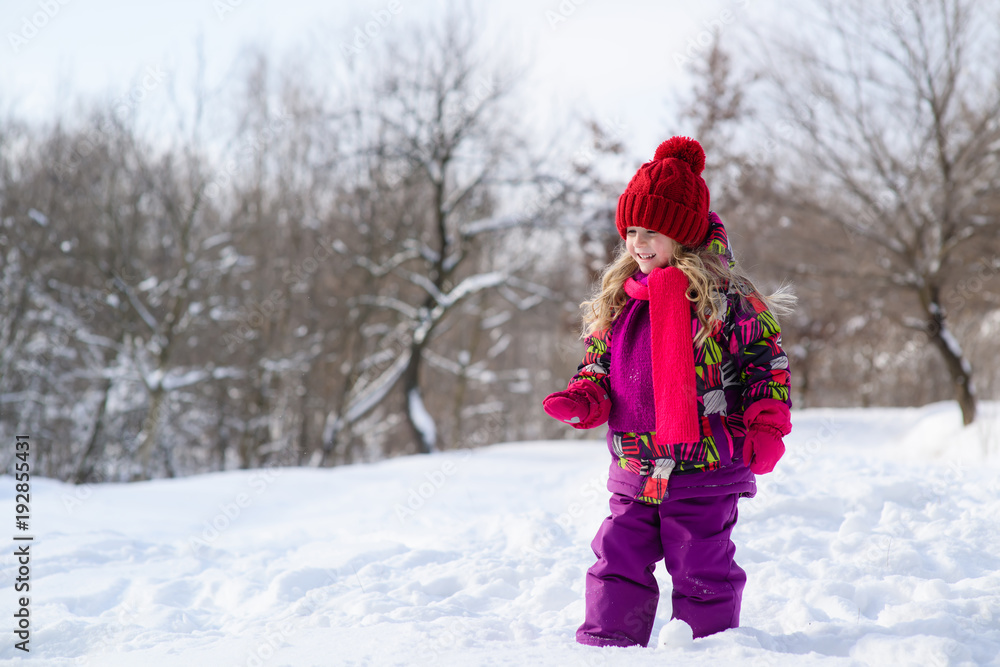 Little cute little girl on a snowy background