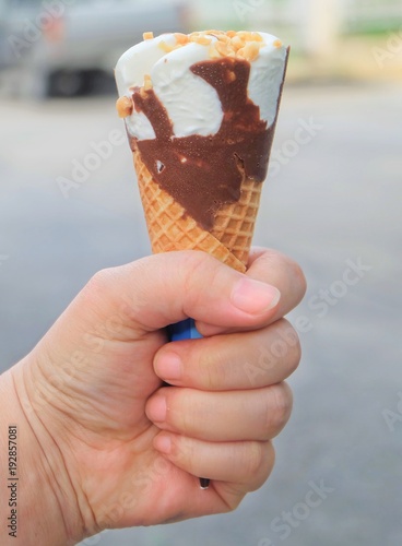 Hand Holding Ice Cream Cones with Chocolate