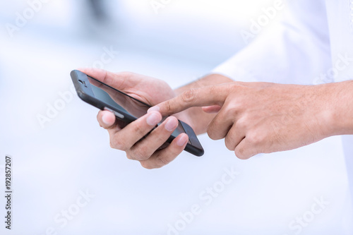 Arab business use mobile phone to connect to customer.