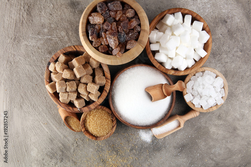 Various types of sugar  brown sugar and white on table