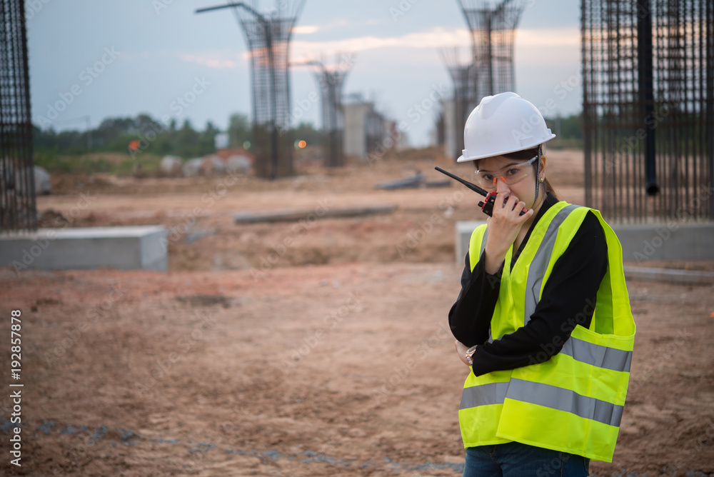 Engineer woman working at site of bridge under construction Engineer woman working at site of bridge under construction
