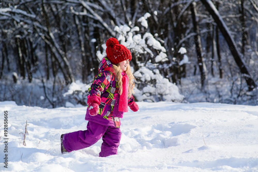 Little cute girl runs through snow