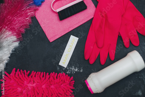 Set of rose cleaning tools: brushes, sponges, sprayer, rubber gloves. A printed AAAH, Clean inscription on a dark concrete background, flat lay. photo