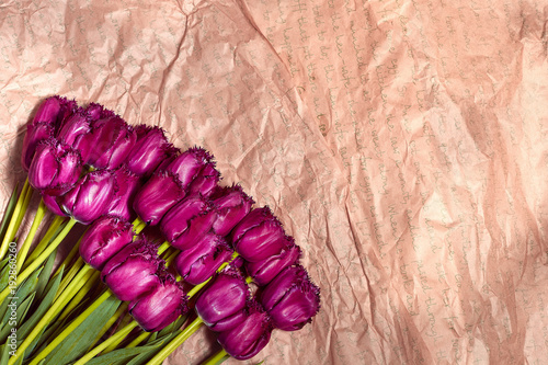 Fresh flower composition, bouquet purple tulips on craft paper background. Valentine, Women's, 8 march, birthday, mother's day present. Copy space, close up, top view. photo