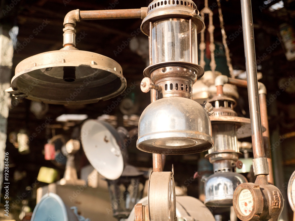 An old, vintage lamp with a shade in an antique store. Antiquarian shop  with old ancient lamps. Antique street shop in Bali. Stock Photo | Adobe  Stock