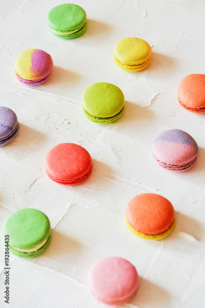 multicolored macaroons on light background, geometric layout multicolored macaroons on light background, geometric layout