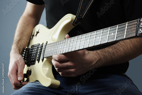 young man holding a electric guitar
