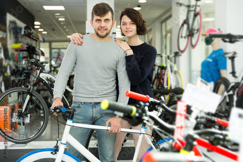 couple standing with bicycle