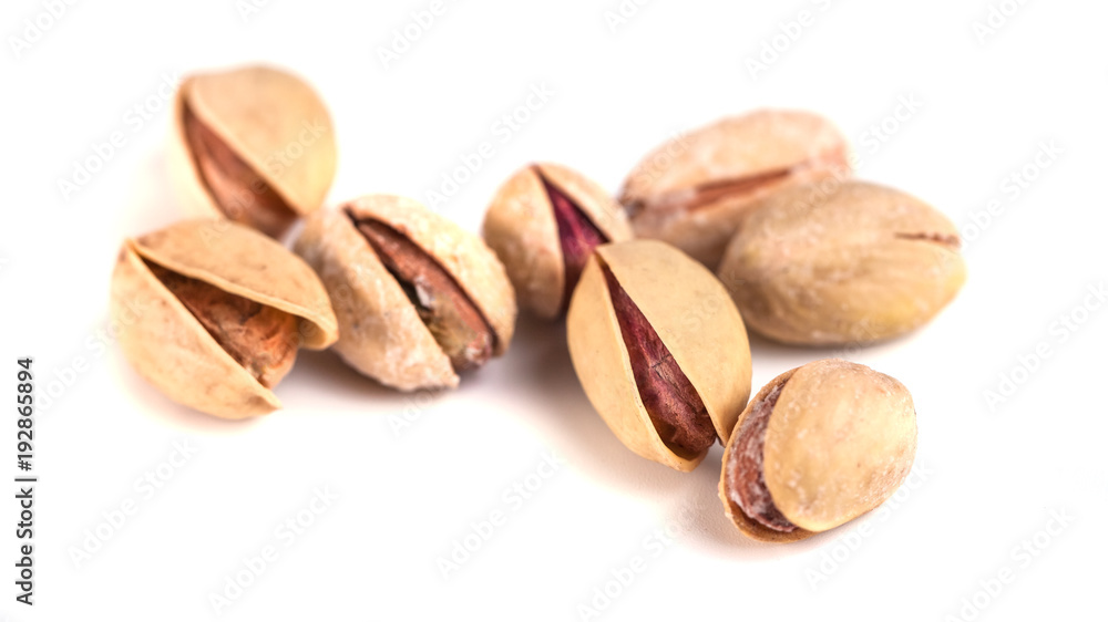 Heap of salted pistachio nuts isolated on a white background Heap of salted pistachio nuts isolated on a white background